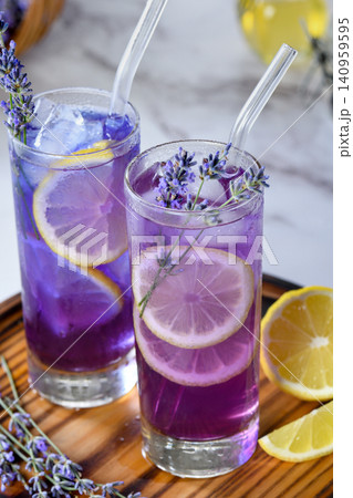 Refreshing lavender lemonade drinks with lemon slices and ice Refreshing lavender lemonade drinks with lemon slices and ice 140959595
