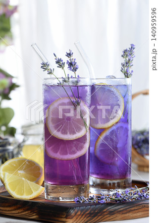 Two glasses of iced purple lavender lemonade with lemon slices Two glasses of iced purple lavender lemonade with lemon slices 140959596