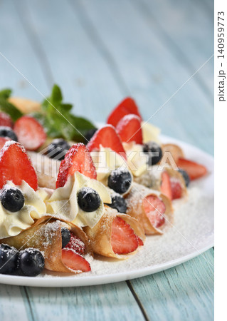 French crepes with cream and berries French crepes with cream and berries 140959773