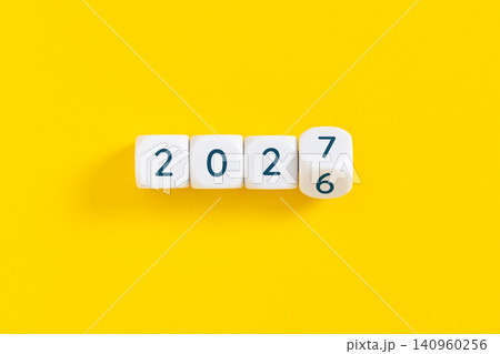 Year 2026 changing to 2027 concept on yellow background 140960256