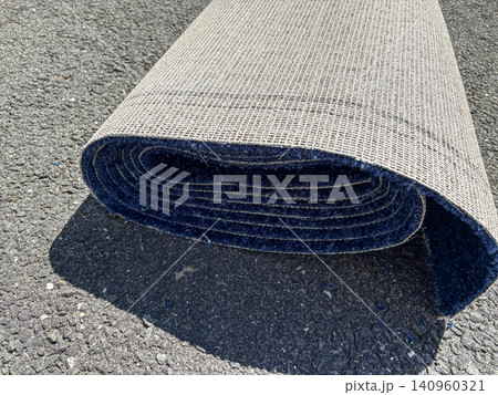 Roll of Blue Carpet on a Driveway Ready to be Installed 140960321