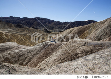 Tourist Observing the Beauty of Zabriiskie Points Landscapes in the Badlands of Death Valley 140960397