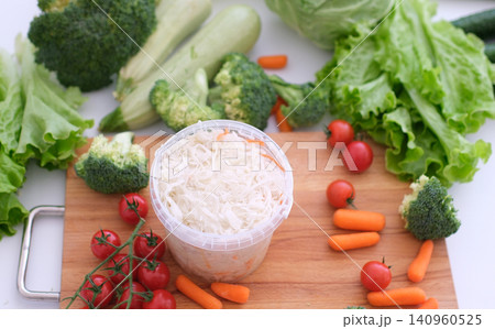 various fresh vegetables sauerkraut sauerkraut in a small jar against the background of a garland various fresh vegetables sauerkraut sauerkraut in a small jar against the background of a garland 140960525