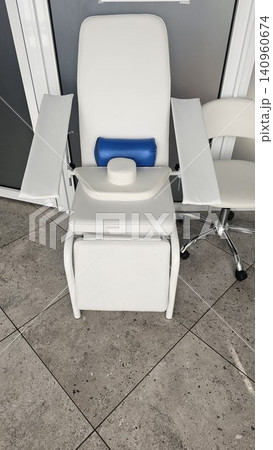 Modern white and gray patient chair near sink and window blinds in stylish hospital office interior with clean medical environment and healthcare design 140960674