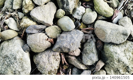 Natural River Stones Texture Background with Green Moss Natural River Stones Texture Background with Green Moss 140961505