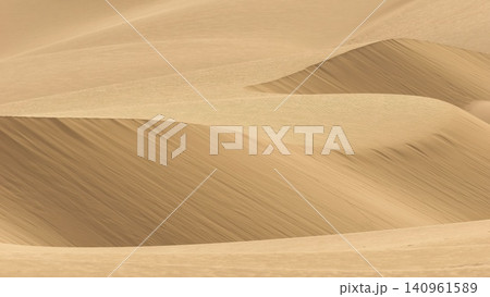 A minimalist perspective on the vast Viana desert landscape in Boa Vista, Cape Verde. The scene is a striking abstract composition formed by the golden sand dunes. A minimalist perspective on the vast Viana desert landscape in Boa Vista, Cape Verde. The scene is a striking abstract composition formed by the golden sand dunes. 140961589