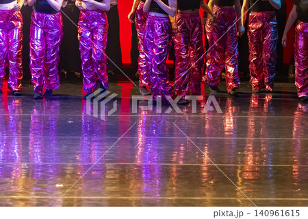 Dancers performing in shiny pink pants on stage Dancers performing in shiny pink pants on stage 140961615