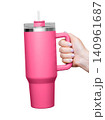 Female Hand Holding 40 oz pink tumbler. Tumbler With Handle, Travel Mug Straw Covers Cup with Lid 140961687