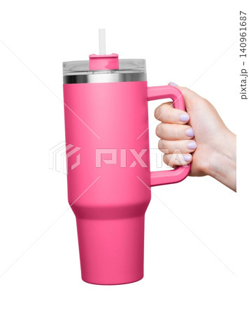 Female Hand Holding 40 oz pink tumbler. Tumbler With Handle, Travel Mug Straw Covers Cup with Lid 140961687