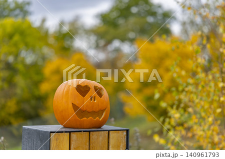 Carved Halloween pumpkin with heart eyes in Prague autumn Carved Halloween pumpkin with heart eyes in Prague autumn 140961793
