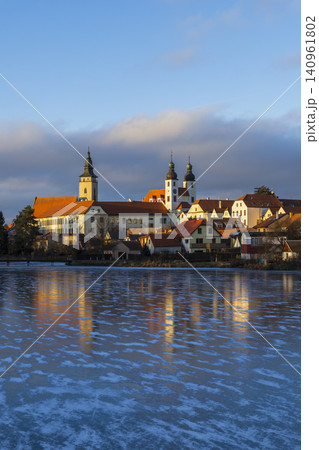 Telc townscape reflecting on frozen lake during winter Telc townscape reflecting on frozen lake during winter 140961802