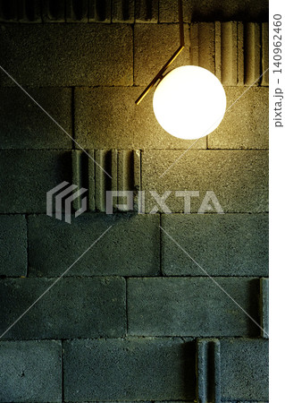 Minimalist Spherical Pendant Light Glowing Against Textured Grey Concrete Wall Background Minimalist Spherical Pendant Light Glowing Against Textured Grey Concrete Wall Background 140962460