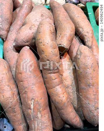 Pile of fresh sweet potatoes close up Pile of fresh sweet potatoes close up 140962494