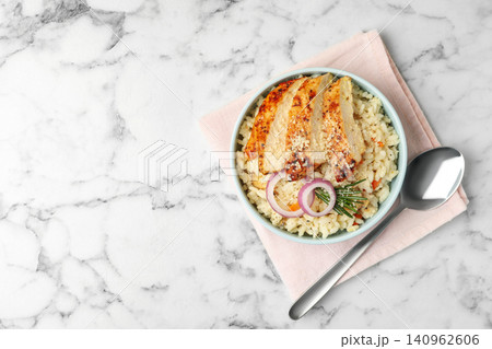 Delicious chicken risotto served on white marble table, flat lay. Space for text Delicious chicken risotto served on white marble table, flat lay. Space for text 140962606