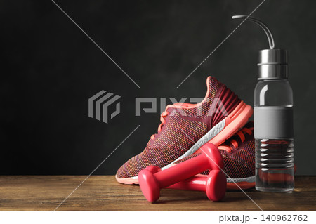 Gym equipment and accessories on floor against dark background. Space for text 140962762
