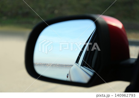 Side rear view mirror of modern car outdoors, closeup Side rear view mirror of modern car outdoors, closeup 140962793
