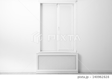 Modern window with closed Roman blinds in empty room Modern window with closed Roman blinds in empty room 140962828