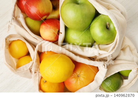 Cotton eco bags with fruits, closeup view Cotton eco bags with fruits, closeup view 140962870