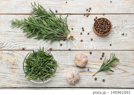 Flat lay composition with fresh rosemary on white wooden table 140962891