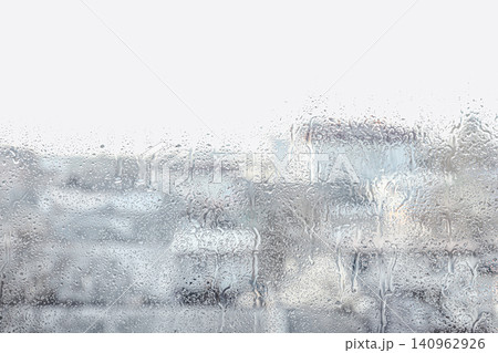 Blurred view of city from window on rainy day Blurred view of city from window on rainy day 140962926