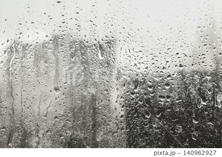 Blurred view of city from window on rainy day Blurred view of city from window on rainy day 140962927