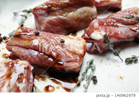 Raw marinated ribs with thyme and peppercorn, closeup Raw marinated ribs with thyme and peppercorn, closeup 140962979
