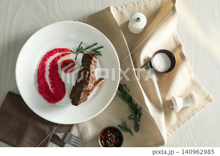 Delicious roasted rib served on white wooden table, flat lay Delicious roasted rib served on white wooden table, flat lay 140962985