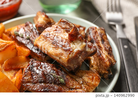 Delicious grilled ribs served on table, closeup Delicious grilled ribs served on table, closeup 140962990