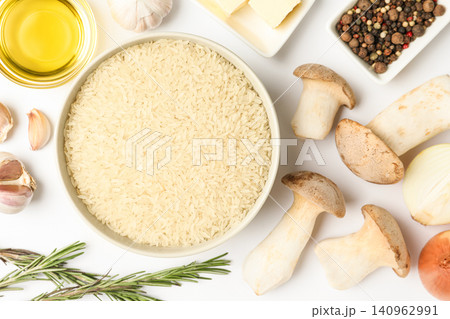 Different ingredients on white background, top view. Risotto recipe Different ingredients on white background, top view. Risotto recipe 140962991