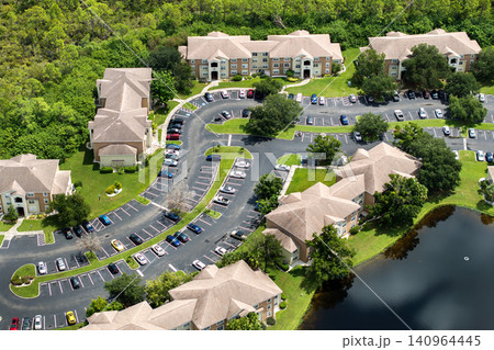 Suburban Florida condos with car parking area, representing family housing and residential planning in the USA Suburban Florida condos with car parking area, representing family housing and residential planning in the USA 140964445