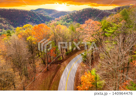 Blue Ridge Parkway in autumn. Mountain pass road between dense woods in seasonal colors in North Carolina Blue Ridge Parkway in autumn. Mountain pass road between dense woods in seasonal colors in North Carolina 140964476