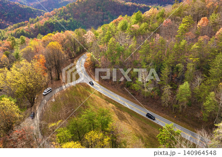Golden autumn landscape in Appalachian mountains of North Carolina. Forest road winds through hills with vibrant fall foliage 140964548