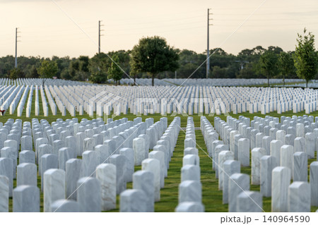 Memorial Day concept. Sarasota National Cemetery with rows of white tomb stones on green grass Memorial Day concept. Sarasota National Cemetery with rows of white tomb stones on green grass 140964590
