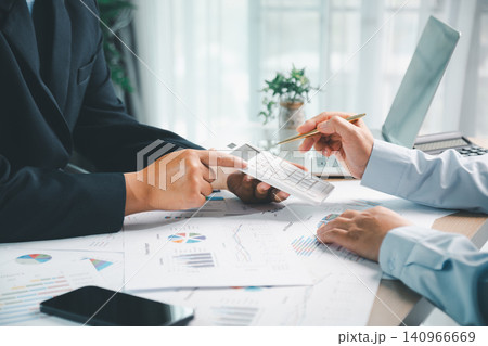 Business team using calculator to review financial reports and sales charts in office, showing accounting, budget planning, tax analysis and corporate teamwork. Business team using calculator to review financial reports and sales charts in office, showing accounting, budget planning, tax analysis and corporate teamwork. 140966669