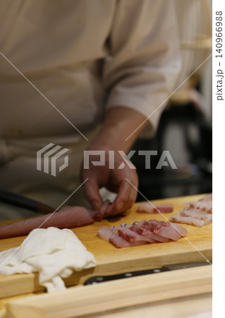 Chef Slicing Meat on Wooden Cutting Board Chef Slicing Meat on Wooden Cutting Board 140966988