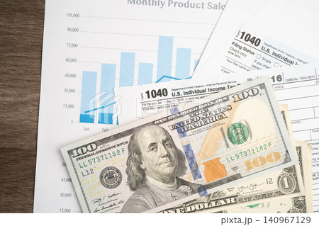 Tax form 1040 U.S. Individual Income Tax Return with dollar banknotes money. Tax form 1040 U.S. Individual Income Tax Return with dollar banknotes money. 140967129