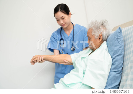 Asian doctor checking and treat elderly woman patient health in hospital. Asian doctor checking and treat elderly woman patient health in hospital. 140967165