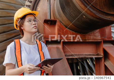 Young Asian engineer teen woman working service power plant turbine fan blade electrical generator Young Asian engineer teen woman working service power plant turbine fan blade electrical generator 140967541