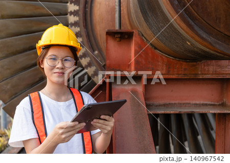 Young Asian engineer teen woman working service power plant turbine fan blade electrical generator Young Asian engineer teen woman working service power plant turbine fan blade electrical generator 140967542