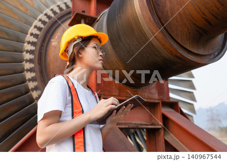 Young Asian engineer teen woman working service power plant turbine fan blade electrical generator Young Asian engineer teen woman working service power plant turbine fan blade electrical generator 140967544
