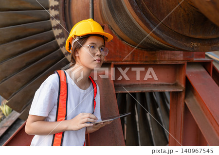 Young Asian engineer teen woman working service power plant turbine fan blade electrical generator Young Asian engineer teen woman working service power plant turbine fan blade electrical generator 140967545