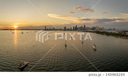 Biscayne Bay with luxury sailboats and yachts in Miami city in Florida, USA. Relaxing on ocean water at sunset Biscayne Bay with luxury sailboats and yachts in Miami city in Florida, USA. Relaxing on ocean water at sunset 140968284
