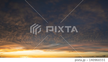 Beautiful sunset sky scenery. Bright colorful orange and yellow clouds on horizon Beautiful sunset sky scenery. Bright colorful orange and yellow clouds on horizon 140968331