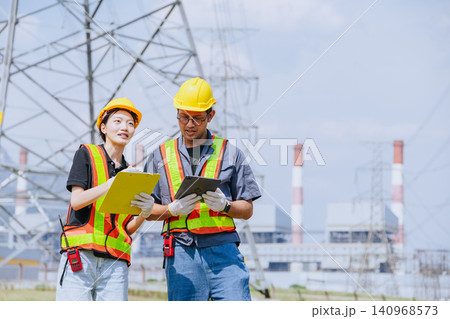 Electricity engineer working team against power plant background and power line survey inspector 140968573
