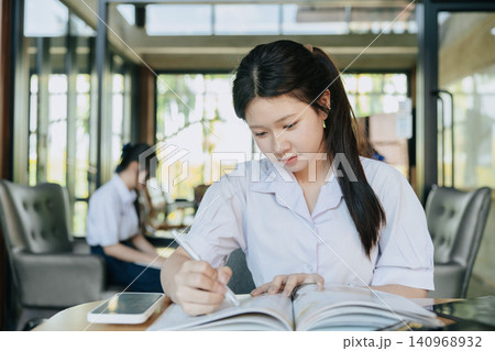 Cute Asian student teen girl, Thai Student study in modern school, Learning education concept. Cute Asian student teen girl, Thai Student study in modern school, Learning education concept. 140968932