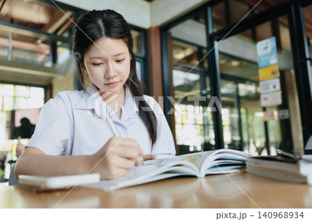 Cute Asian student teen girl, Thai Student study in modern school, Learning education concept. Cute Asian student teen girl, Thai Student study in modern school, Learning education concept. 140968934
