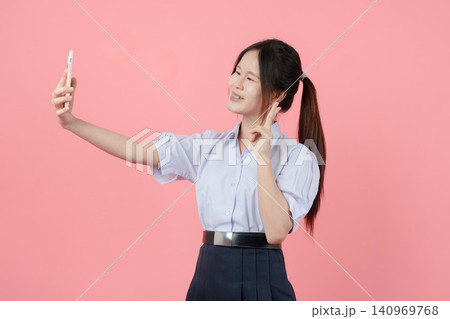 Portrait Thai student in uniform, Asian teen girl cute pretty cheerful happy smiling, Selfie action Portrait Thai student in uniform, Asian teen girl cute pretty cheerful happy smiling, Selfie action 140969768