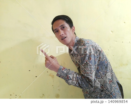 Energetic Asian Man in Batik Showing Hands with Surprised Expression Energetic Asian Man in Batik Showing Hands with Surprised Expression 140969854