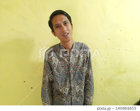 Energetic Asian Man in Batik Showing Hands with Surprised Expression Energetic Asian Man in Batik Showing Hands with Surprised Expression 140969855