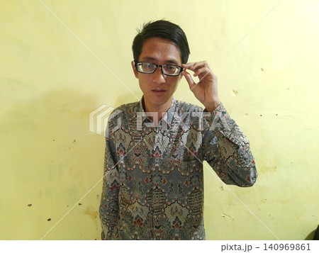 Energetic Asian Man in Batik Showing Hands with Surprised Expression Energetic Asian Man in Batik Showing Hands with Surprised Expression 140969861